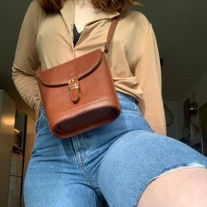 En brun väska tror i fake läder inte säker men super söt är den! 