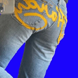 coolest ed hardy jeans  - selling these low waisted jeans with yellow ed hardy hand painted on the back 🥺🥺 fabric paint so the jeans should be hand washed, otherwise amazing quality! 🌸❤️ shipping not included:) 
