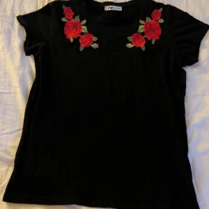 T-shirt - T-shirt från New Yorker med röda rosor på. Aldrig använd, endast tvättad. Storlek M. Bjuder på frakten