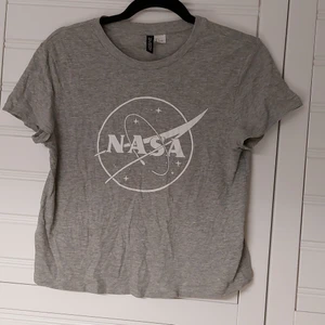 Croppad T-shirt  - Lite croppad grå T-shirt med vitt tryck 