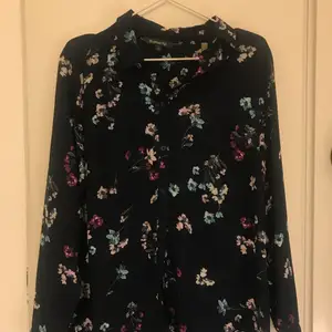 Navy shirt with flower print in perfect condition from the brand Bonmarche. Size is UK 12. Purchased from Bonmarche store in the UK.