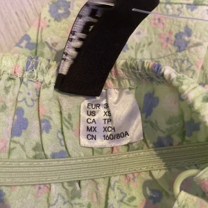 Blommigt linne från H&M - Jag säljer en härlig sommartröja med många detaljer. Säljer då den för att den inte passar mig. Jag kan mötas upp i Täby eller Åkersberga och kan också posta. Köparen står för frakten.