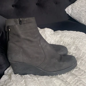 Boots med kilklack i skinn - Svarta boots med kilklack i äkta suede-läder. Väldigt bekväma och passar perfekt till vardags och fest. Nypris ca 1000 kr. Storlek 41. Gott skick!