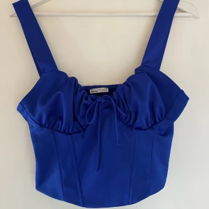 Blå korsettopp - Blå korsettopp med rosett💙 Endast använd en gång till temafest✨