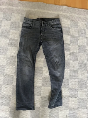 NUDIE JEANS - Gråa nudie jeans. Modellen heter Grim Tim och färgen är ”Pale Grey”. 