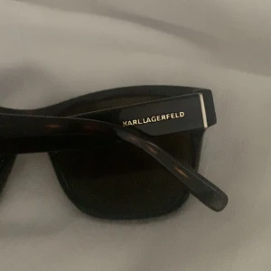 Solglasögon  - Supersnygga solglasögon från Karl Lagerfeld, använd någon enstaka gång men i superfint skick! Färgen är väldigt mörkbrun men ser svart ut i de flesta ljus. Skulle påstå att modellen är unisex och funkar för alla! Pris går att diskuteras vid snabb affär!!!