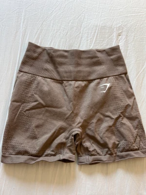 Gymshark shorts - Bruna gymshark shorts storlek S, knappt använda och endast skrynkliga pågrund av att de legat länge i garderoben utan användning, kan tvättas och strykas innan postning så blir dom som nya💕