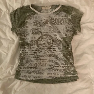 Babytee - En super söt och unik T-shorts med tidnings tryck. Passar så bra till hösten. Super bra skick!