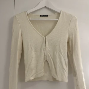 Korsett topp - Ljusbeige stickad tröja med korsett. Aldrig använd