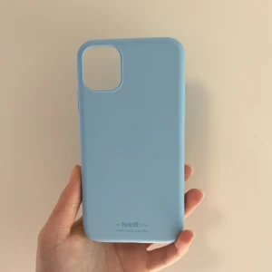 Mobilskal från Holdit - Ett ljusblått mobilskal i silikon från Holdit. Helt utan skador och i bra skick. För iPhone 11