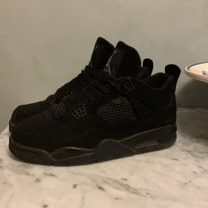 Jordan 4 Black Cat - Jordan 4 Black Cat colorway, storlek 44 Skriv för mer information