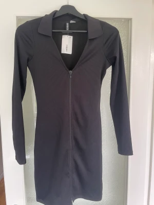 Klänning - Tajt klänning med dragkedja hela vägen. Aldrig använd