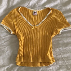 gul lacetop - Gulig gul märkeströja med lace och rosett. Storlek xs-s. Nyskick, inga fläckar. Fråga efter fler bilder💛