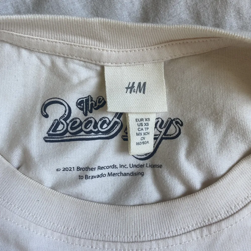 Ljus beige T-shirt med print, lite oversized, från H&M, sparsamt använd! . T-shirts.