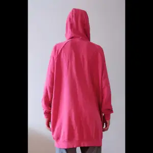 En lite tunnare hoodie från Nike. Lite längre i modellen så den går ner över rumpan.   Färgen är en ganska dämpad  rosa.   Modellen på bilden är 170 cm ca 60 kg