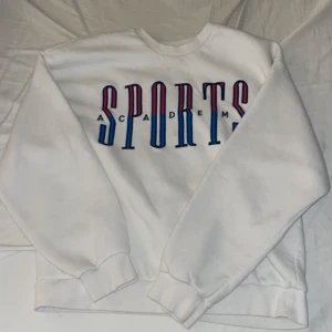 Sweatshirt  - En vit sweatshirt med tryck över bröstet, använd några gånger men inga skavanker 