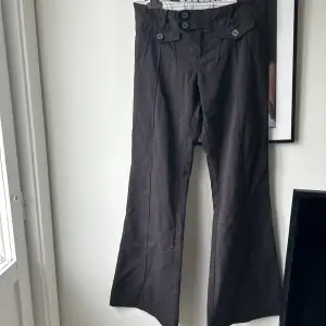 Mörkbruna Kostymbyxor i ”jeansmaterial” med tunna kritränder. Storlek 8 så skulle uppskatta att dem är en 36 i svensk storlek.