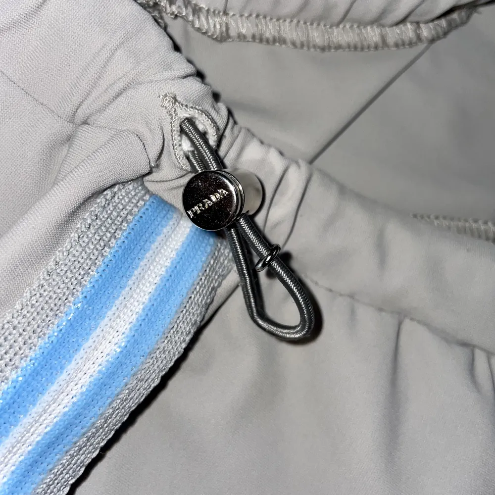 PRADA sport ljusgrå knälånga stretchiga tights med dragsko i midjan och ljusblå/vita revärer i storlek S men kan passa en XS . Shorts.