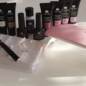 Nagelkit - Komplett polygel nagelkit, använd någon gång.  Innehåller: Lampa, Tip formar, Top coat, klämma, bas3 coat, Slip solution, Pensel, 7 gel färger ( 4 öppnade )