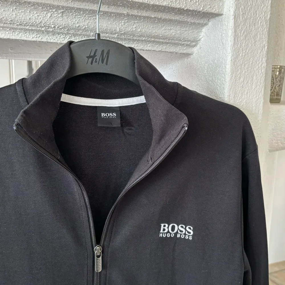 Svart Hugo Boss ziptröja i storlek medium. Sparsamt använd, toppen skick! Normal i storleken, jag är som referens 186cm. . Hoodies.