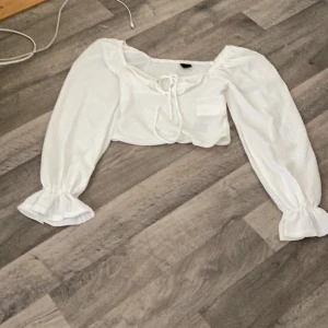 Jätte snygg sommar topp man både kan ha till middag, fest skolavslutning och massor med andra tillfällen. Den har aldrig varit andvänd. - Vit snygg topp har fina detaljer och volanger 