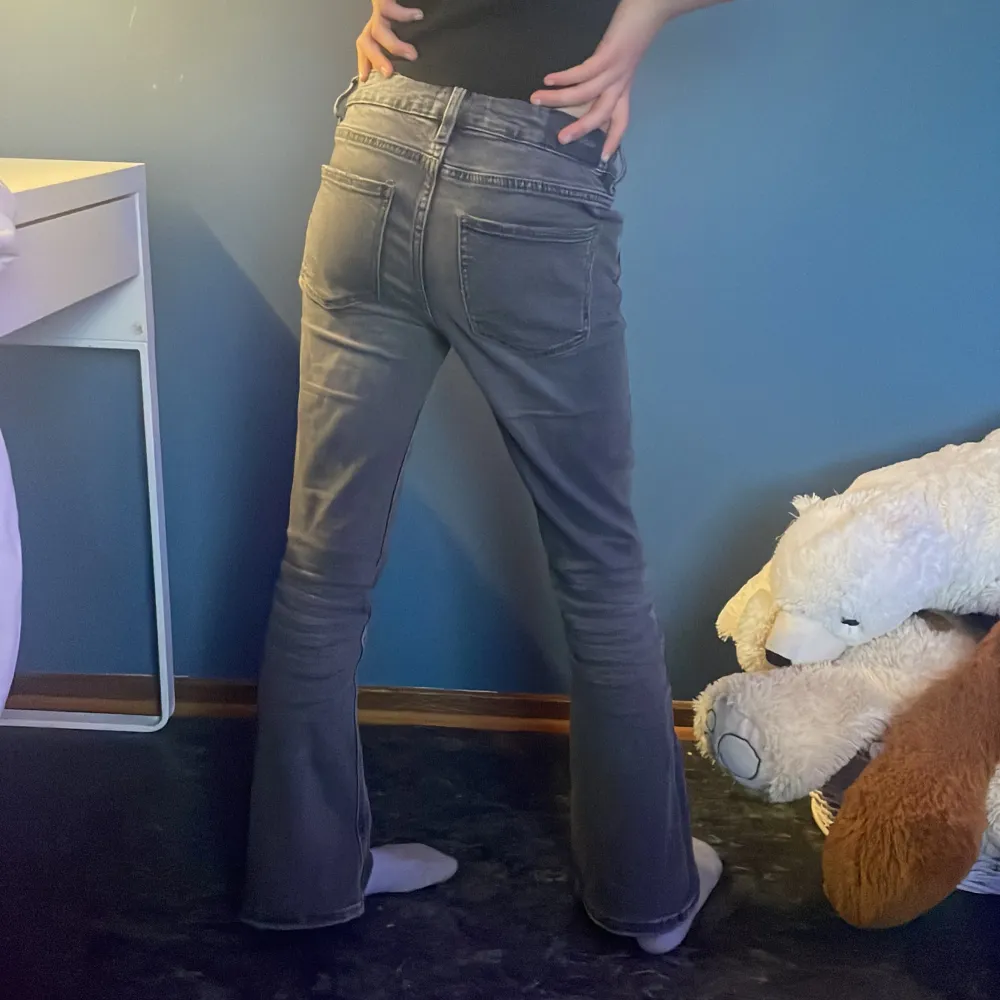 Low waist flare jeans, grå svarta, lite slitna nere vid fötterna. . Jeans & Byxor.