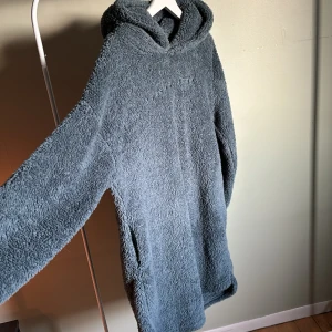 Fluffig lång hoodie - Lång blå fluffig hoodie från Hunkemöller stl M. Knappt använd så i väldigt bra skick. 