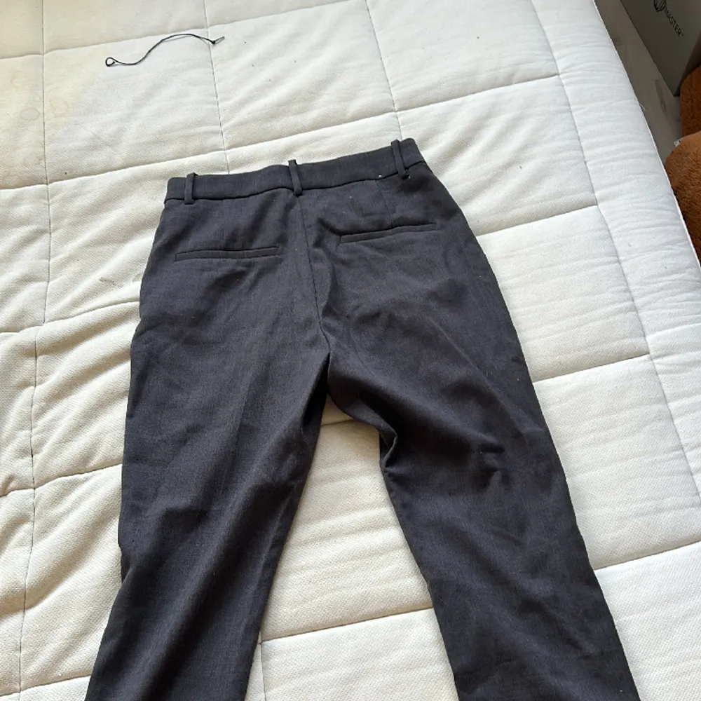 Ett par mörk gråa kostym byxor från hm alldrig använda . Jeans & Byxor.