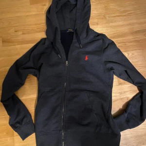 Ralph Lauren zip hoodie - Tjena! Säljer nu min marinblå Ralph Lauren zip hoodie då den ej används längre. Priset är ej hugget i sten. Hör av er vid frågor eller funderingar!