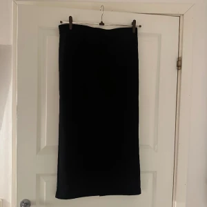 Svart långkjol med slits baktill  - En superfin & elegant långkjol med en slits baktill, från lager 157. Endast använd ett fåtal gånger! Strl M 🖤