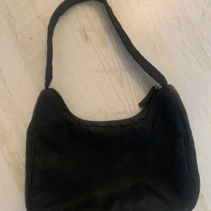 Svart väska  - Svart väska från monki. Litet innerfack. Köpt för flera år sedan men knappt använd. Köparen står för frakt. 