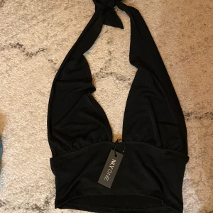 Svart topp - Svart halterneck topp från Nelly. Aldrig använd