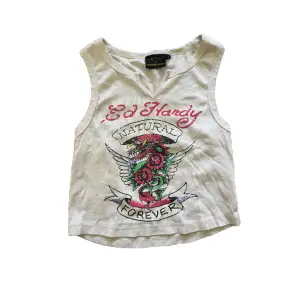 Ed Hardy crop top is in white with a dragon print on the front.  Size s  It's perfect for casual wear
