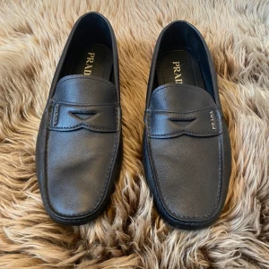Prada - Prada Saffiano Leather  Upper with metal lettering logo applied to  Upper: Saffiano leather the leather saddle Removable insole, Rubber block sole without box  made in Italy