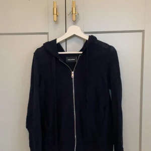 Zadig & Voltaire kaschmir hoodie - Mörkblå zip-up hoodie i mycket mjuk och högkvalitativ kaschmir. Har armbågslappar i läder med silvrig färg i stjärnform. Var sliten på höger armbåge, men nu lagad, dock ev perfekt heller. Annars inga imperfektioner.