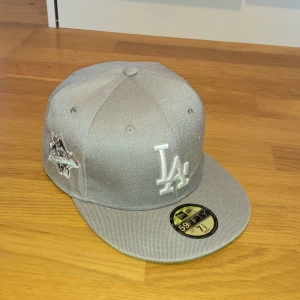 New Era Keps - Säljer min New Era keps i färgen grå då den är för liten för mig. Använd ett par gånger, fast kommer i riktigt bra skick. Storlek (7) 1/2. Vill man ha fler bilder så är det bara att skriva så fixar jag det. Priset kan diskuteras vid snabb affär.