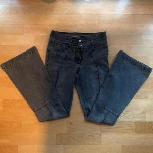 Fina bootcut jeans - Ett par söta gråa jeans med fin röd detalj! De är bootcut, storlek 34. Fantastiskt skick, inga tydliga defekter, knappt använda. Kan skicka fler bilder vid behov.