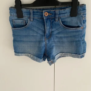 Blå jeansshorts  - Snygga blå jeansshorts från LAB Industries med klassisk femficksdesign och råa, fransiga benslut. Shortsen har normal passform, knapp och dragkedja framtill samt bälteshällor. Perfekta för varma sommardagar.🏝️🩷