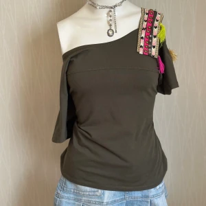 Olivgrön topp med axeldekoration Flower - Embroidery off the shoulder T-shirt  Missing some stones  Kolla gärna på mina andra mina andra annonser 