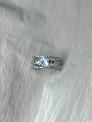 Lumen Grace - Beaded design with a striking central stone. Adjustable