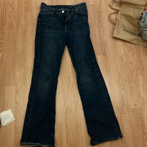 Mörkblå bootcut jeans  - Säljer ett par mörkblå jeans från hm med klassisk femficksdesign och bootcut-ben. Jeansen har normal passform och är tillverkade i slitstarkt denimtyg. Perfekta för dig som gillar en tidlös och avslappnad look. Storlek 160/164 men är lite långa för mig som är 164.