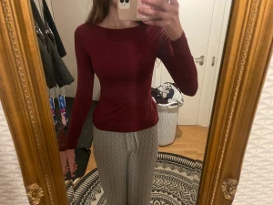 Vinröd långärmad topp från SHEIN - Säljer en vinröd långärmad topp från SHEIN i storlek XS. Toppen är figurnära med rund hals och tillverkad i mjuk polyester med lite stretch för skön passform. Perfekt att styla med jeans eller kjol för en clean look.