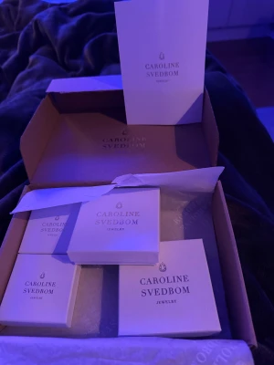 Caroline Svedbom armband och örhängen - Säljer en Caroline Svedbom box med armband och ett par örhängen i, säljer eftersom jag fick väldigt mycket dubbelt av Caroline Svedbom i konfirmations present. Det är inget fel på smyckena och aldrig använda förutom det armbandet med pärlor i så är det en pärla som har åkt av som ni ser. Jag kan absolut sälja det i styck eller t.ex ett armband och örhängena om man inte vill köpa hela boxen med allt i eftersom det är två dubbletter, då kan pris diskuteras. Hör av er vid frågor eller intresse!💕💕