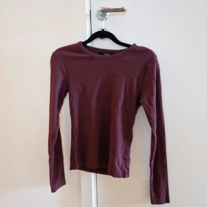 Vinröd långärmad topp - Från Vero Moda, använd två gånger. Stretchigt material. Ribbad.
