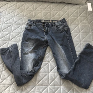 LAB Industries Luke Slim Fit jeans - Snygga mörkblå jeans från LAB Industries i modellen Luke Slim Fit. Jeansen har klassisk femficksdesign, slitningar och tvättade detaljer för en cool look. Tillverkade i hållbar denim med smal passform och normal midja.