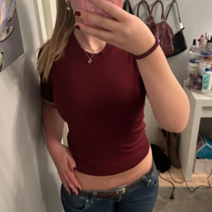 Vinröd kortärmad stickad tröja - Säljer en vinröd stickad t-shirt från Lager 157 i storlek xs. Materialet känns mjukt och stretchigt, vilket gör den bekväm att bära. Använd en gång 💕.