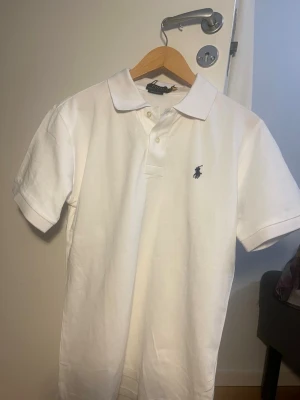 Vit Polo Ralph Lauren t-shirt slim fit - Vit kortärmad t-shirt från Polo Ralph Lauren i modellen Custom Slim Fit. Perfekt till middag eller när man vill känna sig stilig. T shirten är helt oanvänd och ny skick. Storleken är S 