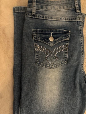 Jeans med broderad bakficka - Använda men i bra skick.                                                  Ganska stretchiga så borde passa strl M också