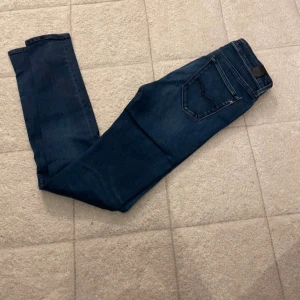 Replay Hyperflex skinny jeans blå - Mörkblå Replay Hyperflex jeans med skinny fit och klassisk femficksdesign. Jeansen är tillverkade i stretchigt denim för extra komfort och har en snygg, smal siluett. Perfekta för dig som gillar en tajt passform och stilren look.