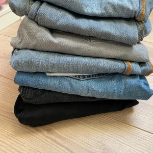 Mix av jeans och vita byxor - Säljer ett gäng byxor: flera par klassiska blå och svarta jeans, ett par grå jeans samt två par vita byxor. Perfekt för dig som vill variera stilen med både denim och ljusa plagg. Jeans med olika tvättar och raka eller smalare ben, samt vita byxor i mjukt material. Jeansen kommer från Lager 157